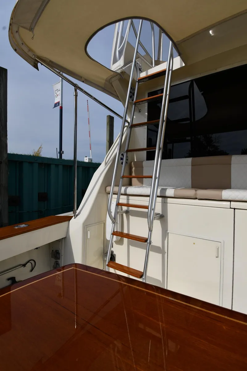 Slide: The Image of 1990 Viking 53 Convertible yacht with ladder and polished wood deck. - 22