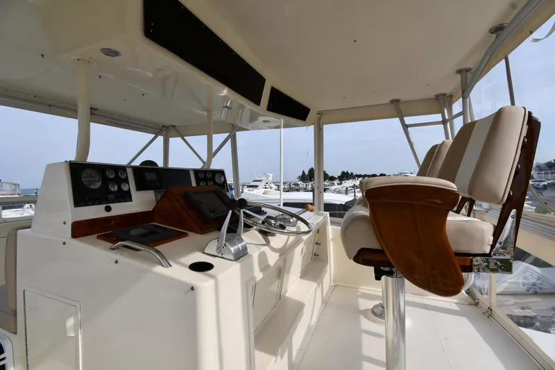 Slide: The Image of Helm of 1990 Viking 53 Convertible yacht with control panel and captain's chairs. - 23