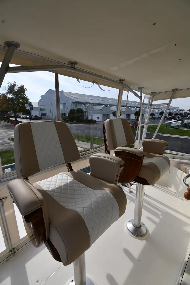 Slide: The Image of Captain's chairs on 1990 Viking 53 Convertible yacht, featuring beige and white upholstery. - 28
