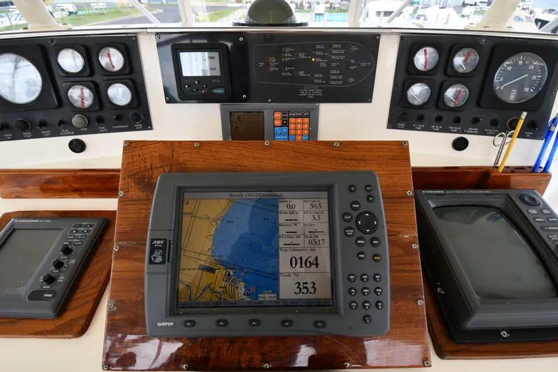 Slide: The Image of Control panel of a 1990 Viking 53 Convertible yacht with navigation instruments. - 30