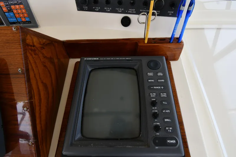 Slide: The Image of 1990 Viking 53 Convertible boat control panel with navigation equipment and pens. - 32