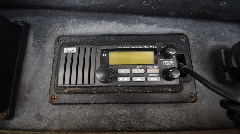 Slide: The Image of ICOM marine radio on 1990 Viking 53 Convertible boat dashboard. - 36
