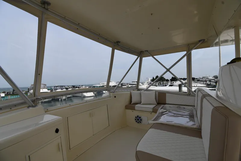 Slide: The Image of 1990 Viking 53 Convertible yacht interior with seating, overlooking marina. - 38