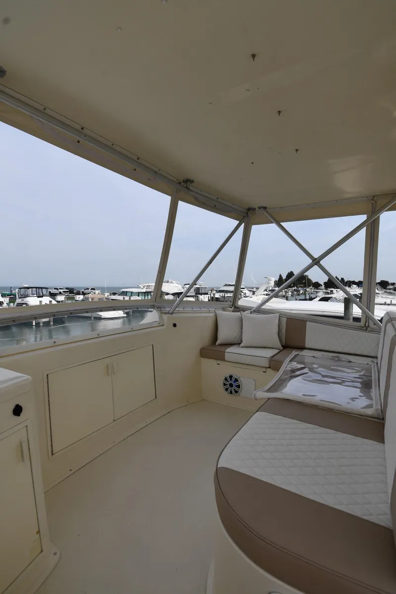 Slide: The Image of 1990 Viking 53 Convertible yacht interior with seating, overlooking marina. - 39