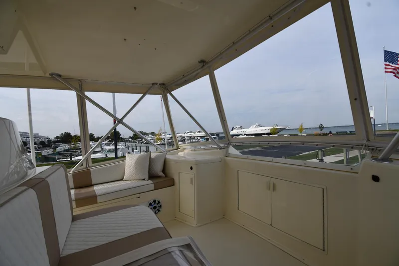 Slide: The Image of Interior view of 1990 Viking 53 Convertible yacht with seating and marina backdrop. - 40