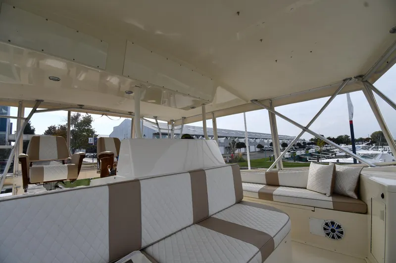 Slide: The Image of Interior of 1990 Viking 53 Convertible yacht with cushioned seating and open views. - 42
