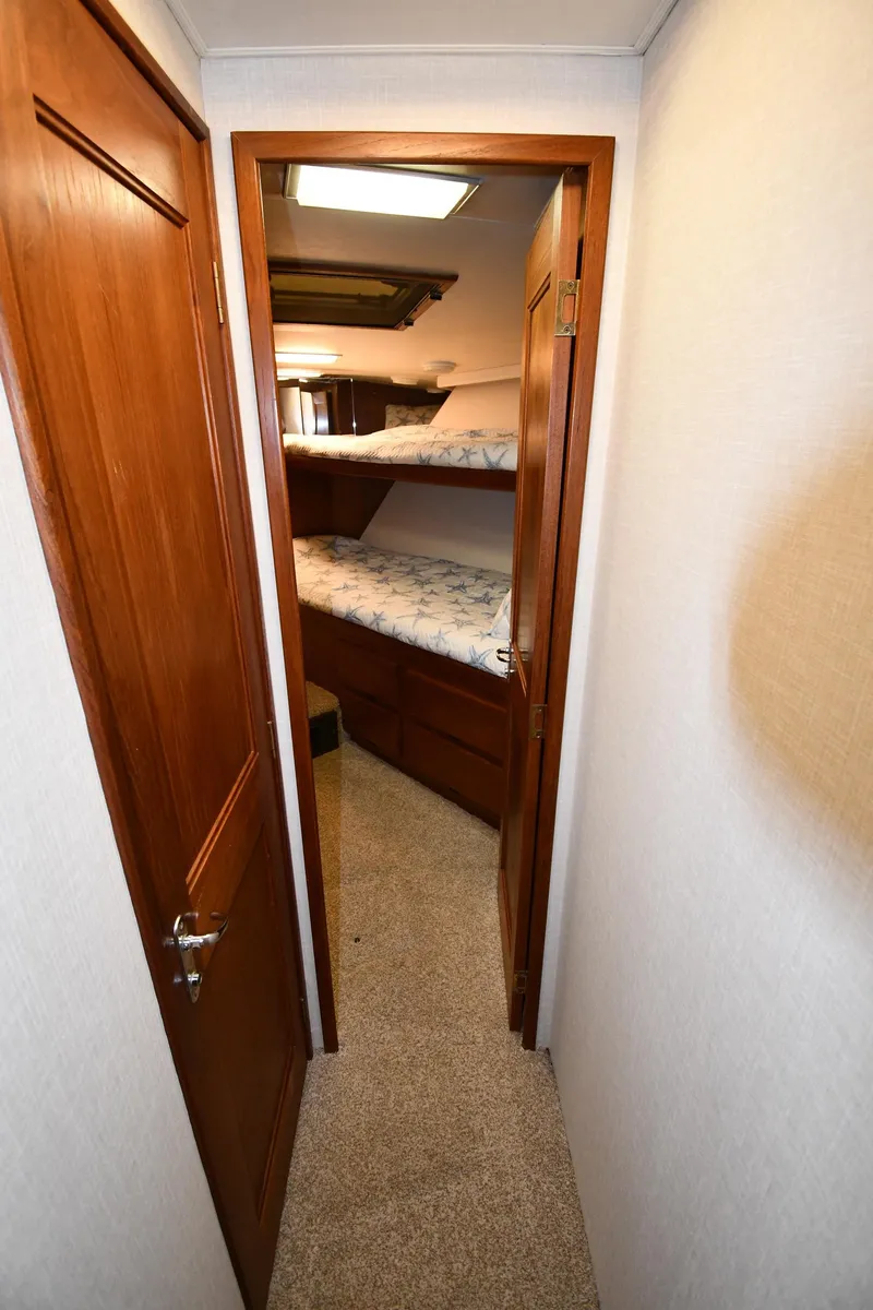 Slide: The Image of Interior hallway of 1990 Viking 53 Convertible yacht with wooden doors and bunk beds. - 46