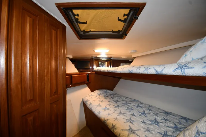 Slide: The Image of Interior of 1990 Viking 53 Convertible yacht with wooden bunk beds and overhead hatch. - 47