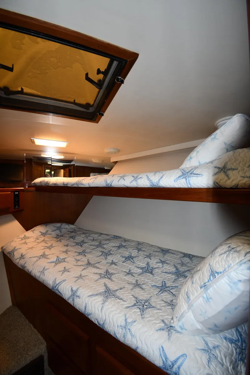 Slide: The Image of Bunk beds in 1990 Viking 53 Convertible yacht cabin with starfish-patterned bedding. - 48
