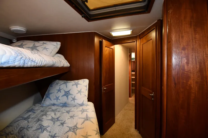 Slide: The Image of Interior of 1990 Viking 53 Convertible yacht with wooden bunk beds and starfish-patterned bedding. - 49