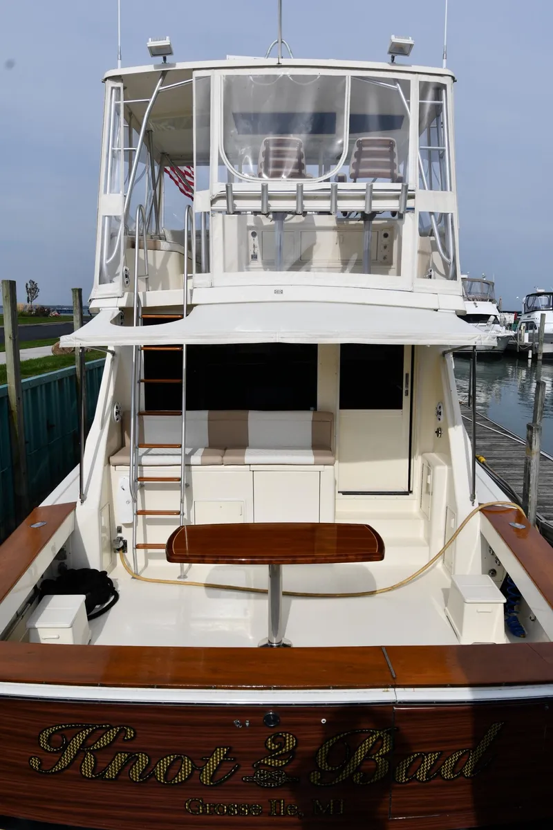 Slide: The Image of 1990 Viking 53 Convertible yacht docked, featuring spacious deck and flybridge. - 6