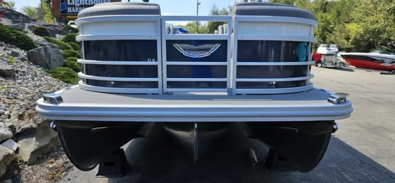 Slide: The Image of 2025 Bennington 23 RSB pontoon boat front view, parked outdoors. - 1