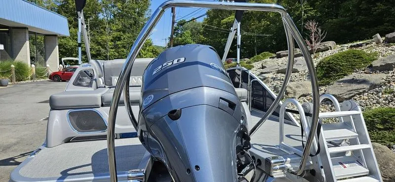 Slide: The Image of 2025 Bennington 23 RSB pontoon boat with powerful 250 HP engine, outdoor setting. - 11
