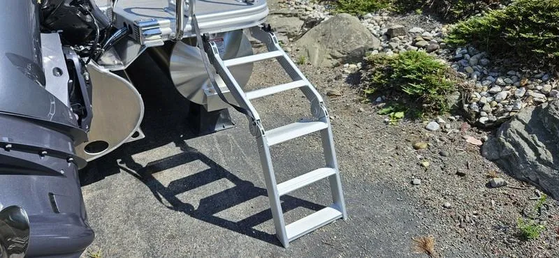 Slide: The Image of Bennington 23 RSB 2025 boat ladder on rocky shore. - 12