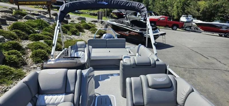 Slide: The Image of 2025 Bennington 23 RSB pontoon boat with luxurious seating and canopy in a marina setting. - 7