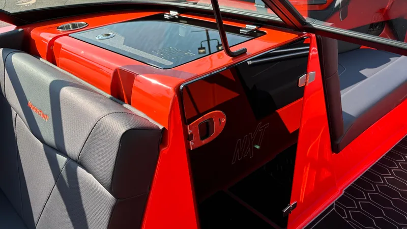 Slide: The Image of 2025 MasterCraft NXT24 boat interior with red and black design. - 14