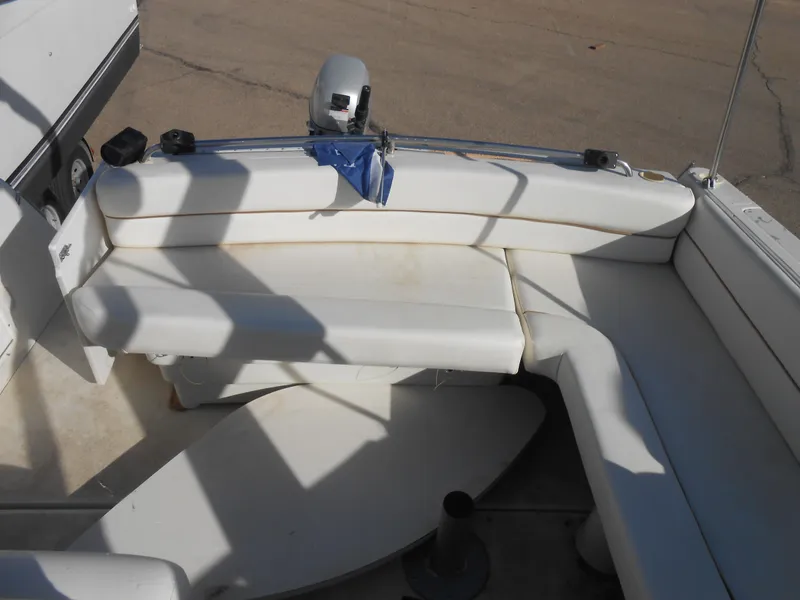 Slide: The Image of 1995 Larson 280 Cabrio boat interior with white seating and equipment. - 10