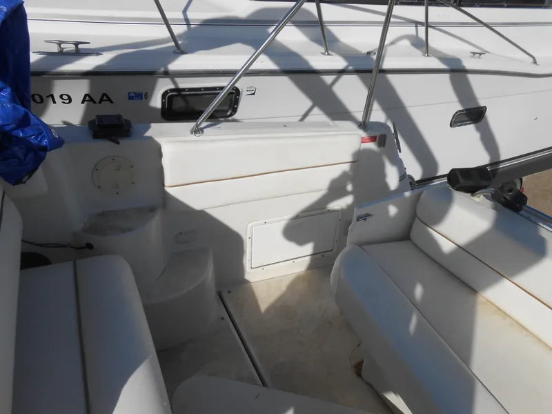 Slide: The Image of 1995 Larson 280 Cabrio boat interior with white seating and railing. - 11
