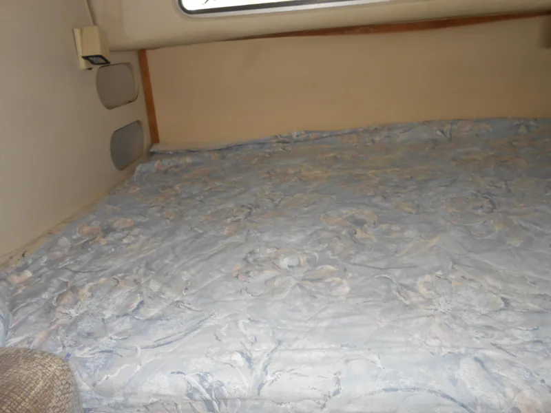 Slide: The Image of Interior cabin bed of 1995 Larson 280 Cabrio boat with floral bedding. - 17