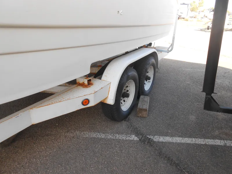 Slide: The Image of Trailer with dual wheels supporting a 1995 Larson 280 Cabrio boat. - 2