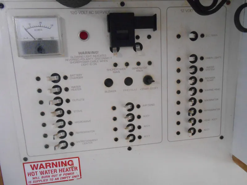 Slide: The Image of Control panel of a 1995 Larson 280 Cabrio boat with various switches and warning labels. - 21