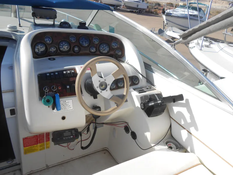 Slide: The Image of 1995 Larson 280 Cabrio boat dashboard with steering wheel and instrument panel. - 6