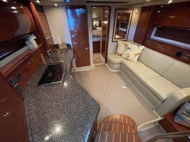 Slide: The Image of Interior of 2005 Sea Ray 390 Sundancer yacht with kitchen and seating area. - 11