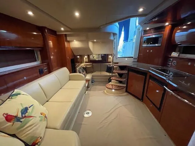 Slide: The Image of Luxurious interior of 2005 Sea Ray 390 Sundancer yacht with elegant seating and modern kitchen. - 12