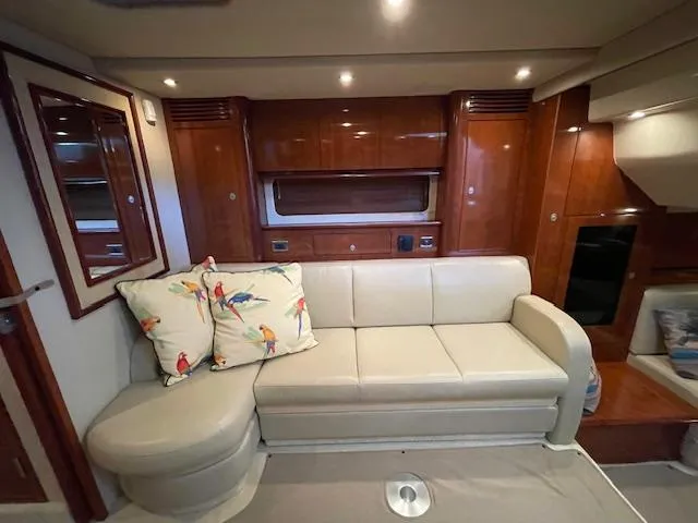 Slide: The Image of Interior of 2005 Sea Ray 390 Sundancer with beige sofa and decorative pillows. - 13