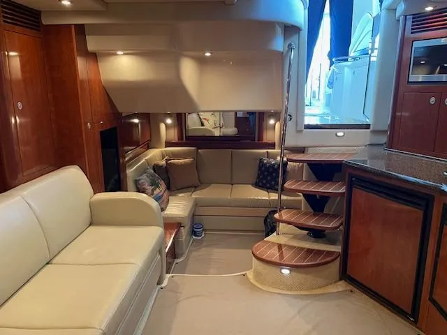 Slide: The Image of Luxurious interior of 2005 Sea Ray 390 Sundancer yacht with elegant seating and wooden accents. - 14