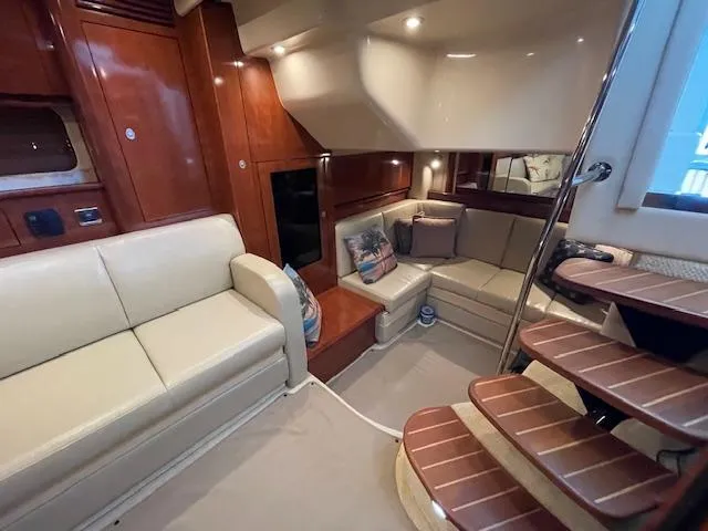 Slide: The Image of Luxurious interior of 2005 Sea Ray 390 Sundancer yacht with plush seating and wooden accents. - 15