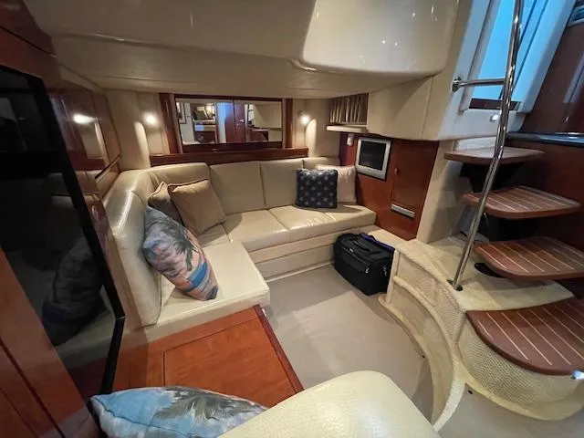 Slide: The Image of Interior of 2005 Sea Ray 390 Sundancer yacht with cozy seating and elegant design. - 16