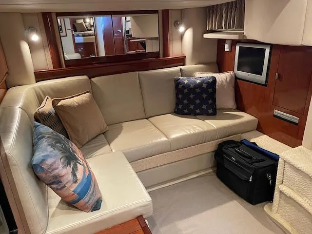 Slide: The Image of Interior of 2005 Sea Ray 390 Sundancer with beige seating and decorative pillows. - 17