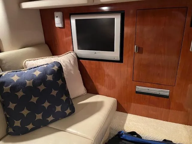 Slide: The Image of Interior of 2005 Sea Ray 390 Sundancer with TV and cushioned seating. - 18