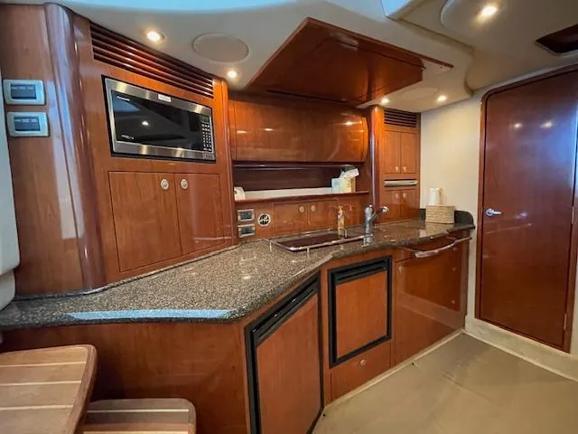 Slide: The Image of Luxurious 2005 Sea Ray 390 Sundancer yacht interior with modern kitchen amenities. - 20