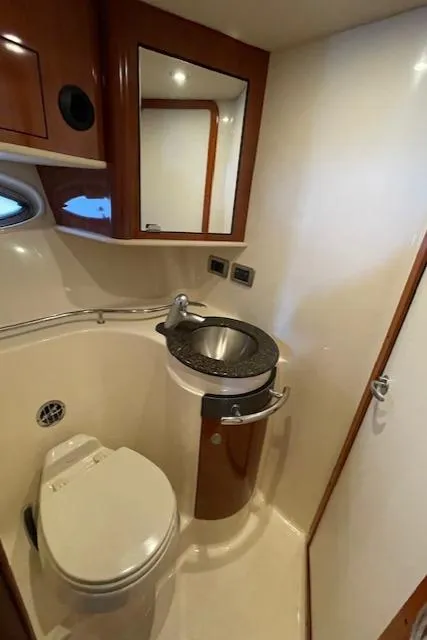 Slide: The Image of 2005 Sea Ray 390 Sundancer bathroom with modern sink and toilet. - 24