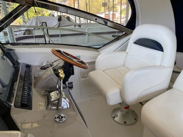 Slide: The Image of Captain's seat and helm of 2005 Sea Ray 390 Sundancer yacht. - 4