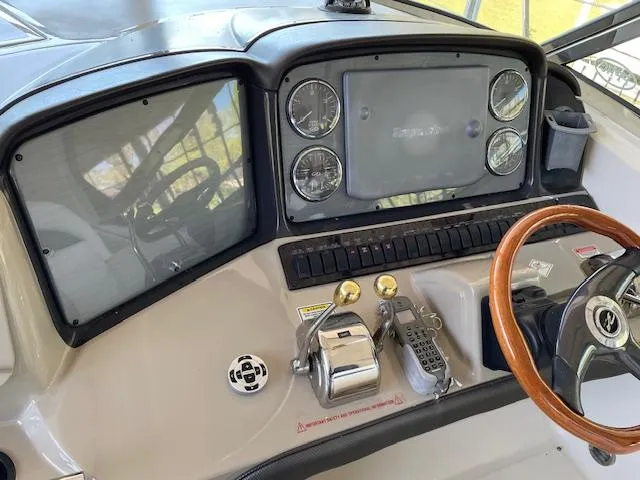 Slide: The Image of Helm of 2005 Sea Ray 390 Sundancer with gauges, controls, and wooden steering wheel. - 5