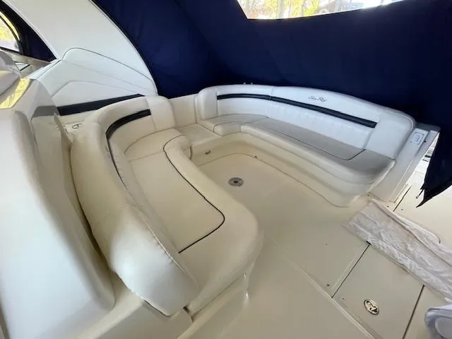 Slide: The Image of 2005 Sea Ray 390 Sundancer interior with white leather seating and elegant design. - 9