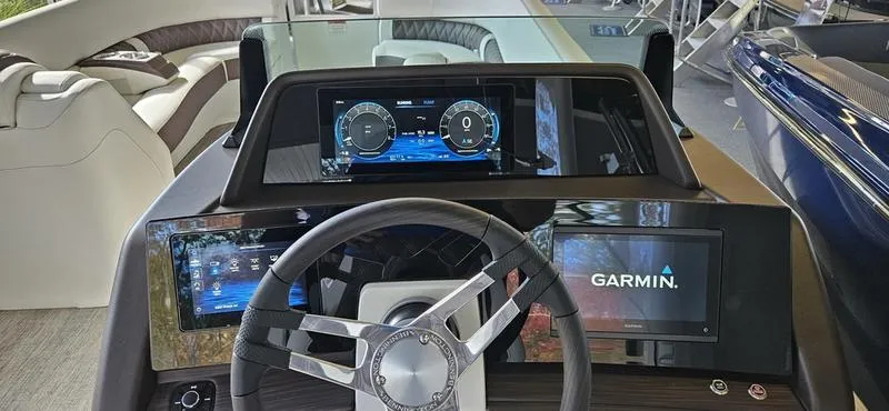 Slide: The Image of 2025 Bennington R 25 RSBA boat dashboard with Garmin navigation system and modern controls. - 2