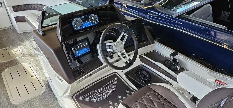 Slide: The Image of 2025 Bennington R 25 RSBA boat interior with modern dashboard and steering wheel. - 9