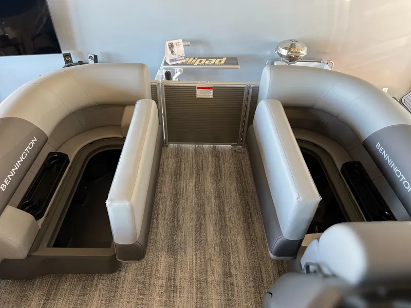 Slide: The Image of 2025 Bennington 168 SL boat interior with gray seating and storage compartments. - 10