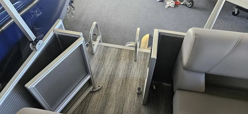 Slide: The Image of 2025 Bennington 168 SL boat interior with gray seating and carpeted flooring. - 7
