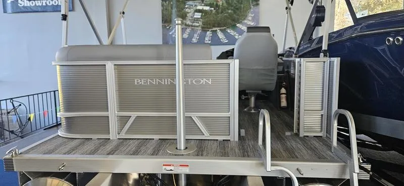 Slide: The Image of 2025 Bennington 168 SL pontoon boat displayed in a showroom setting. - 8