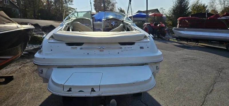 Slide: The Image of 2001 Sea Ray 230 Bow Rider boat, rear view, parked outdoors. - 4