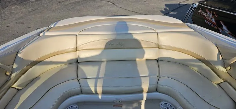 Slide: The Image of 2001 Sea Ray 230 Bow Rider with beige seating and shadow on deck. - 6