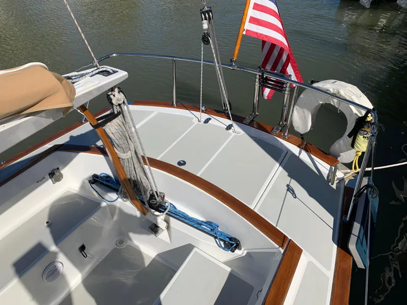Slide: The Image of 2022 Tartan Fantail sailboat deck with American flag, docked on calm water. - 10