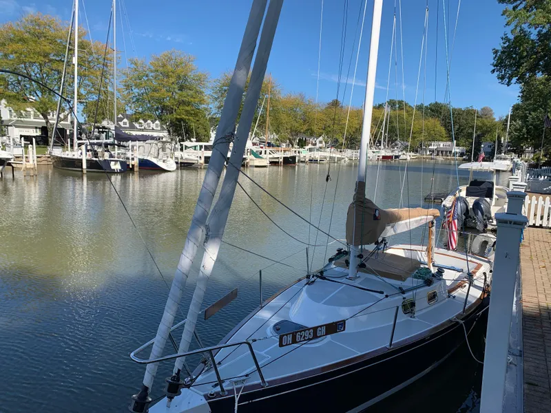 Slide: The Image of 2022 Tartan Fantail sailboat docked in a serene marina setting. - 14