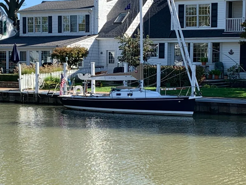 Slide: The Image of 2022 Tartan Fantail sailboat docked by a charming waterfront house. - 18