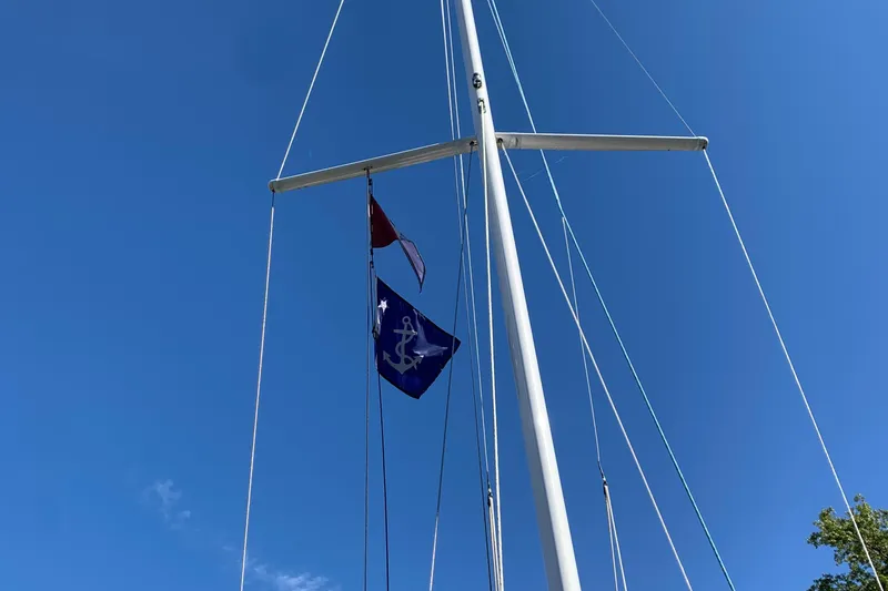 Slide: The Image of Sailboat mast with flags against clear blue sky, Tartan Fantail 2022 model. - 22